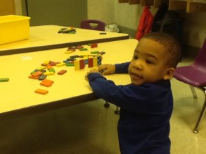 Toddler with Dominoes