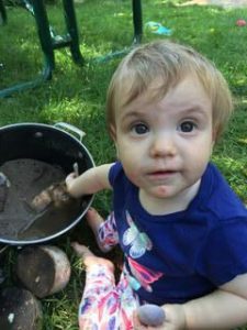 toddler baking wiht mud