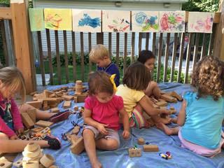 children with outdoor blocks