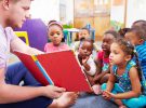 Volunteer teacher reading to a class of preschool kids